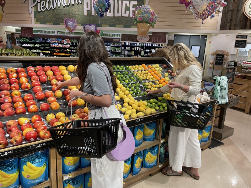 two women shopping in the produce section of Lowes Foods